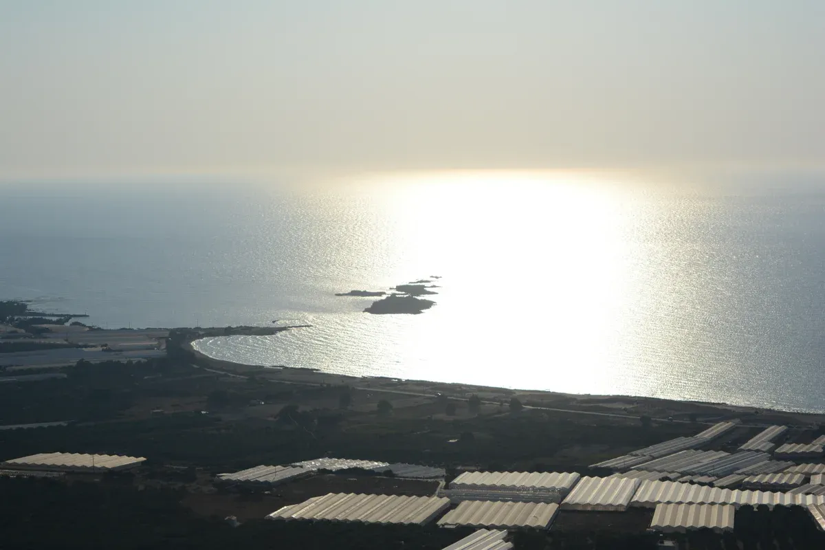 Wide sandy shoreline and turquoise shallows at Falassarna beach on Crete's west coast