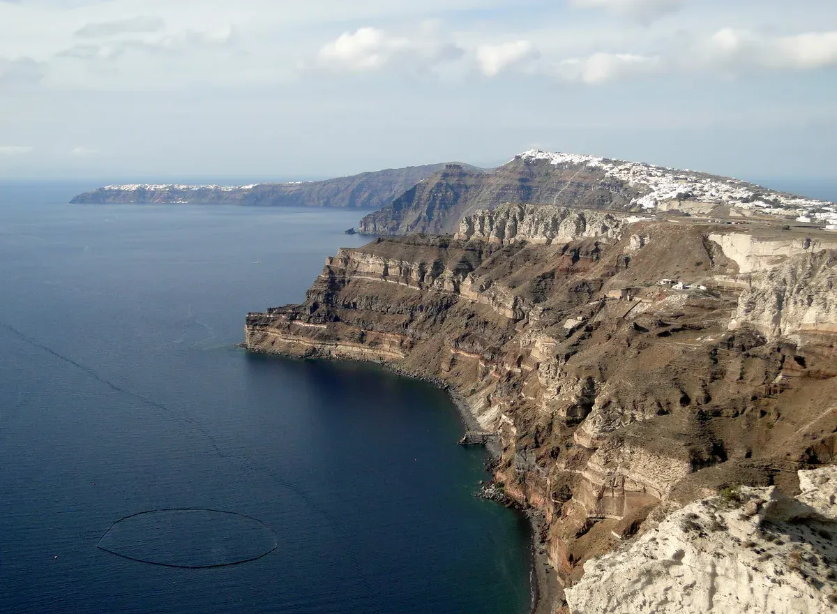 Oia and Fira seen together along the Santorini caldera cliffs on a day trip from Crete